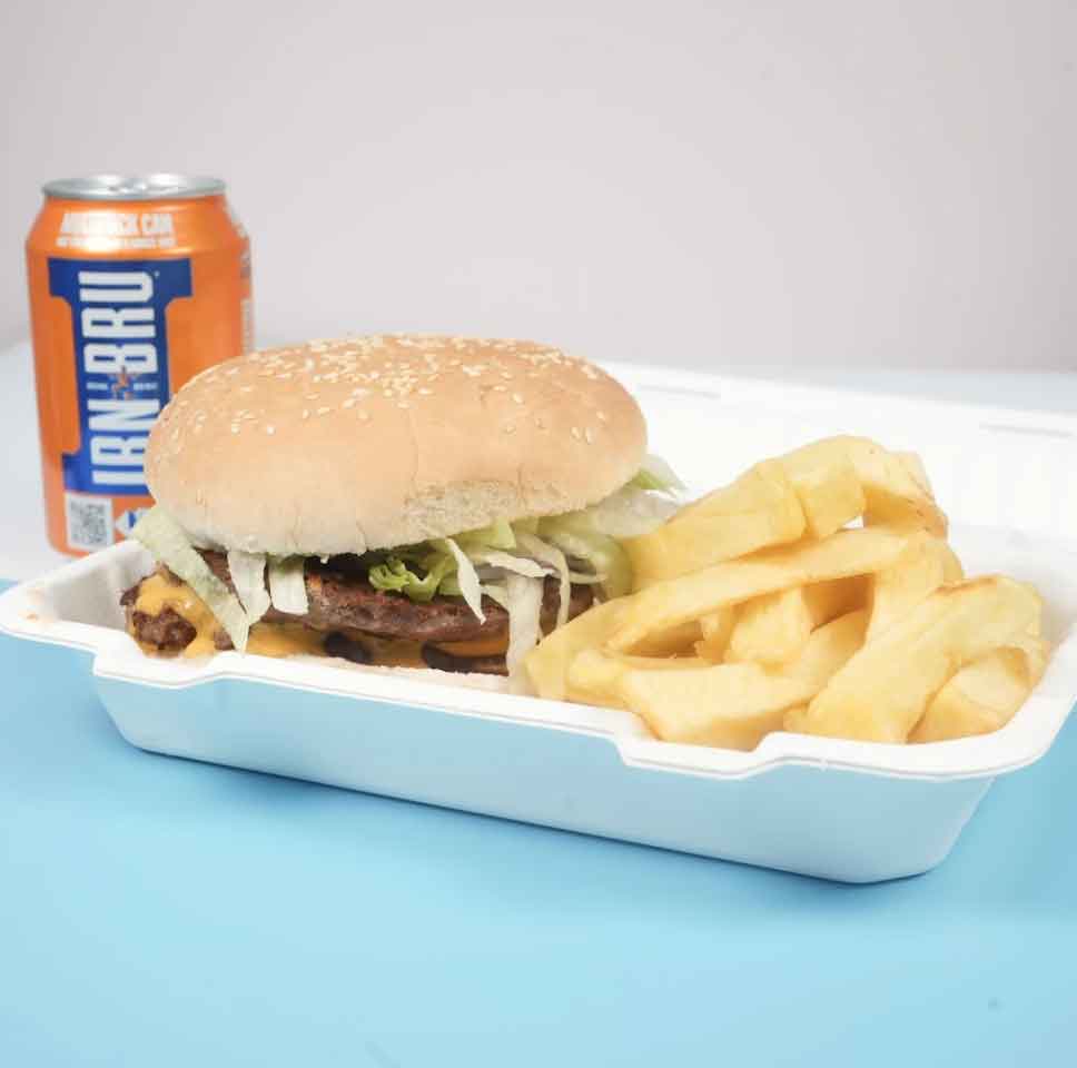 A double cheeseburger with shredded lettuce and a side of chunky fries.